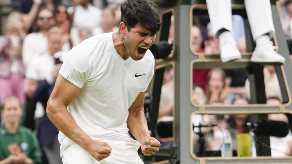 Carlos Alcaraz of Spain reacts after defeating Ugo Humbert of France in their fourth round match at the Wimbledon tennis championships in London, Sunday, July 7, 2024. (AP Photo/Alberto Pezzali)