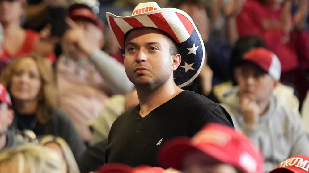 A supporter listens as Republican presidential nominee former President Donald Trump speaks at a campaign rally at the Bryce Jordan Center, Saturday, Oct. 26, 2024, in State College, Pa. (AP Photo/Alex Brandon)