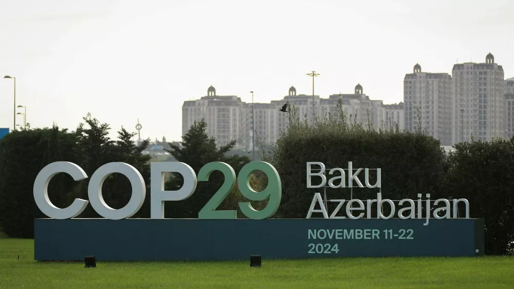 FILE PHOTO: A view shows a sign of the COP29 United Nations Climate Change Conference with a backdrop of the cityscape in Baku, Azerbaijan October 31, 2024. REUTERS/Aziz Karimov/File Photo