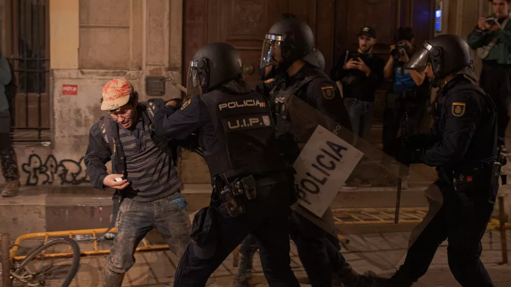 09 November 2024, Spain, Valencia: Police charge against a protester during clashes as demonstartors demand the resignation of of regional head Carlos Maz&oacute;n over handling of recent deadly floods in Valencia. Photo: Elena Fernandez/ZUMA Press Wire/dpa