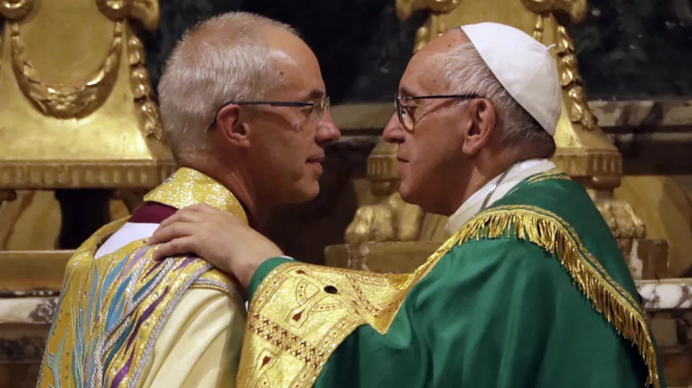 Pope Francis, right, greets the archbishop of Canterbury, Justin Welby, during vespers prayers in the church of San Gregorio al Celio, in Rome, Wednesday, Oct. 5, 2016. Francis joined the archbishop of Canterbury, Justin Welby, for a vigil prayer service Wednesday at Rome's church of St. Gregory. The church is named for the 6th century pope who dispatched missionaries to England to spread Christianity. (AP Photo/Gregorio Borgia)