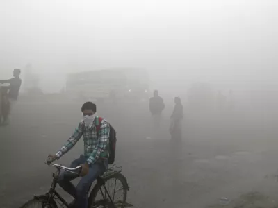 Indian commuters wait for transport amid thick blanket of smog on the outskirts of New Delhi, India, Friday, Nov. 10, 2017. As air pollution peaked this week in Delhi, it rose to more than 30 times the World Health Organization&acirc;&euro;&trade;s recommended safe level. Experts have compared it to smoking a couple of packs of cigarettes a day. A recent report by the Lancet medical journal estimated that a quarter of all premature deaths in India, some 2.5 million each year, are caused by pollution. (AP Photo/Altaf Qadri)