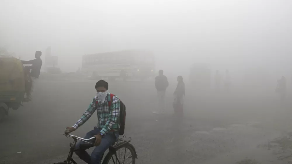 Indian commuters wait for transport amid thick blanket of smog on the outskirts of New Delhi, India, Friday, Nov. 10, 2017. As air pollution peaked this week in Delhi, it rose to more than 30 times the World Health Organization&acirc;&euro;&trade;s recommended safe level. Experts have compared it to smoking a couple of packs of cigarettes a day. A recent report by the Lancet medical journal estimated that a quarter of all premature deaths in India, some 2.5 million each year, are caused by pollution. (AP Photo/Altaf Qadri)