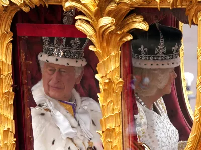 06 May 2023, United Kingdom, London: King Charles III (L)&nbsp;and Queen Camilla are carried in the Gold State Coach, pulled by eight Windsor Greys, in The Coronation Procession as they return along The Mall to Buckingham Palace, London, following their coronation ceremony. Photo: Niall Carson/PA Wire/dpa