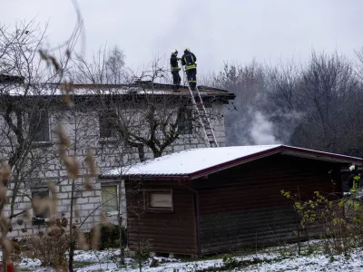 Lithuanian Emergency Ministry employees work at the site where a DHL cargo plane crashed into a house near Vilnius, Lithuania, Monday, Nov. 25, 2024. (AP Photo/Mindaugas Kulbis)