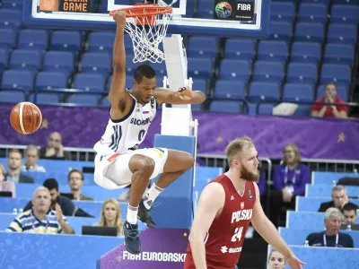 Slovenia's Anthony Randolph dunks the ball as Poland's Przemyslaw Karnowski, right, looks on during their Eurobasket European Basketball Championship match in Helsinki, Thursday Aug. 31. 2017. (Juss Nukari/Lehtikuva via AP)