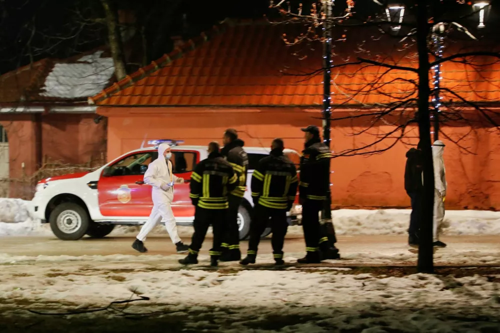 A forensic technician walks on a street near the scene where a gunman opened fire at a restaurant and killed several people in Cetinje, Montenegro, January 1, 2025. REUTERS/Stevo Vasiljevic