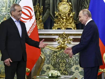 Russian President Vladimir Putin, right, and Iranian President Masoud Pezeshkian arrive to attend talks at the Kremlin in Moscow, Russia, Friday, Jan. 17, 2025. (Evgenia Novozhenina/Pool Photo via AP)