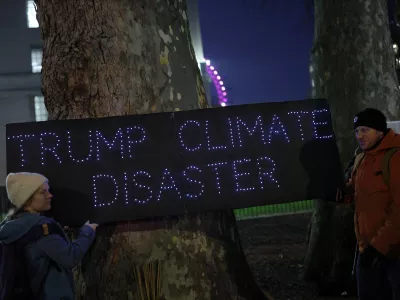 Demonstrators hold a placard that reads "Trump Climate Disaster" during a protest against the inauguration of Donald Trump as U.S. president, in London, Britain, January 20, 2025. REUTERS/Isabel Infantes