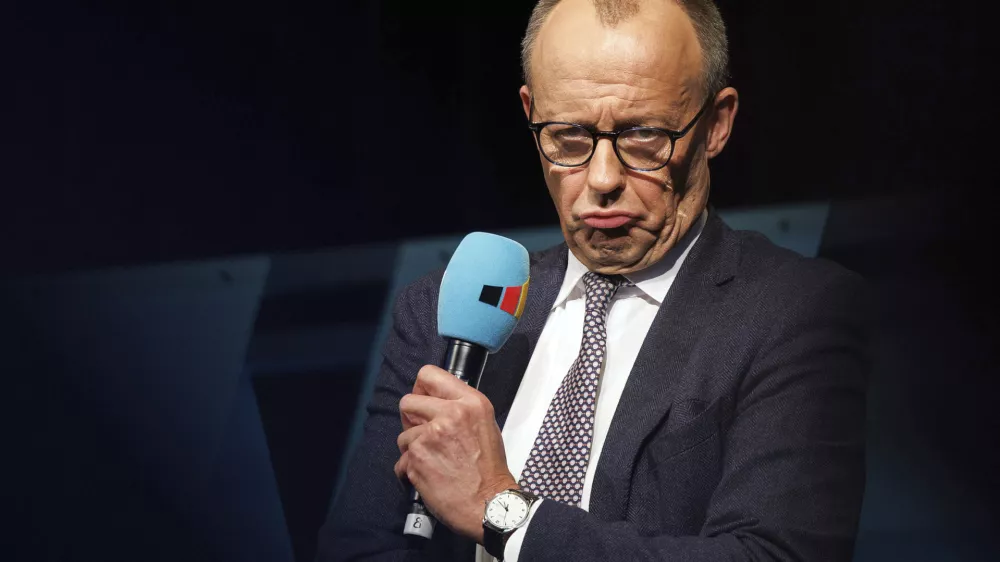 Federal Chairman of the CDU and candidate for Chancellor of the Union, Friedrich Merz speaks at a campaign event for the 2025 Bundestag election campaign, at the Neuhof community center, in Neuhof, Germany, Saturday, Jan. 25, 2025. (Lando Hass/dpa via AP)