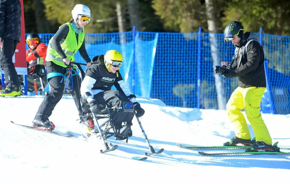 Paraplegiki so osvajali smučarske ve&scaron;čine s pmočjo smučarskih učiteljev. Foto: ZPS