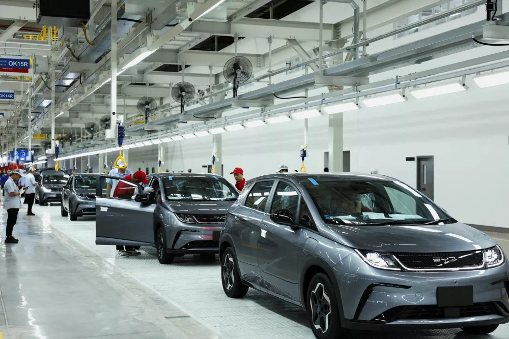 FILE PHOTO: Workers check the EV cars inside BYD's first electric vehicle (EV) factory in Southeast Asia, a fast-growing regional EV market where it has become the dominant player, in Rayong, Thailand, July 4, 2024. REUTERS/Chalinee Thirasupa/File Photo