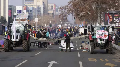 Tractors and cars block a road during an ongoing protest over the collapse of a concrete canopy that killed 15 people more than two months ago, in Novi Sad, Serbia, Sunday, Feb. 2, 2025. (AP Photo/Darko Vojinovic)