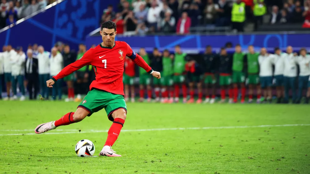 FILED - 05 July 2024, Hamburg: Portugal's Cristiano Ronaldo shoots his penalty during the UEFA EURO 2024 quarter-final soccer match between Portugal and France at the Volksparkstadion Hamburg. Photo: Jens B&uuml;ttner/dpa