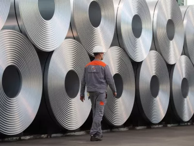 FILED - 12 July 2020, Lower Saxony, Salzgitter: An employee walks along coiled steel at Salzgitter AG. US&nbsp;President Donald Trump's announcement that he is planning to impose 25% tariffs&nbsp;on steel and aluminium imports is hitting the EU&nbsp;steel sector at the worst possible time, a German industry association said on&nbsp;Monday. Photo: Julian Stratenschulte/dpa