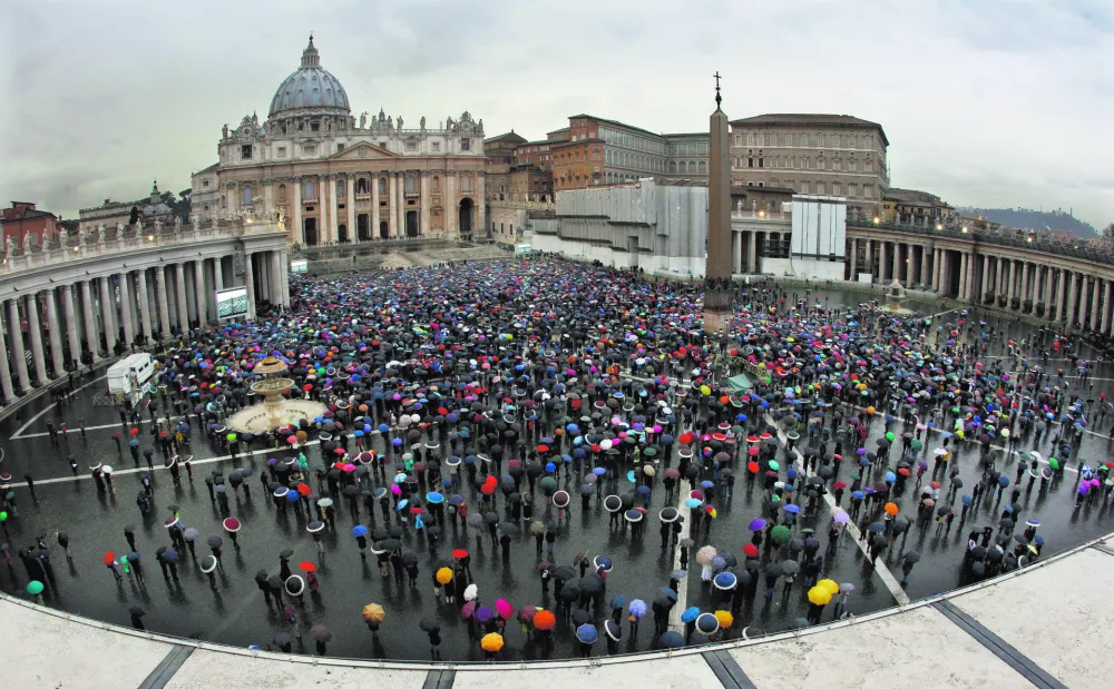 Crowds gather in St. Peter's Square to wait for the election of a new pope by the cardinals in conclave in the Sistine Chapel at the Vatican, Wednesday, March 13, 2013. (AP Photo/Andrew Medichini)