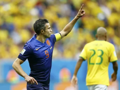 Robin van Persie of the Netherlands celebrates after scoring a goal from a penalty kick during their 2014 World Cup third-place playoff against Brazil at the Brasilia national stadium in Brasilia July 12, 2014. REUTERS/Dominic Ebenbichler (BRAZIL - Tags: SOCCER SPORT WORLD CUP)    TOPCUP