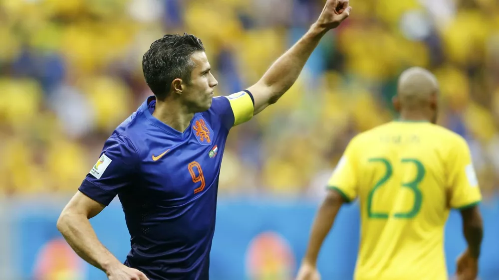 Robin van Persie of the Netherlands celebrates after scoring a goal from a penalty kick during their 2014 World Cup third-place playoff against Brazil at the Brasilia national stadium in Brasilia July 12, 2014. REUTERS/Dominic Ebenbichler (BRAZIL - Tags: SOCCER SPORT WORLD CUP)    TOPCUP