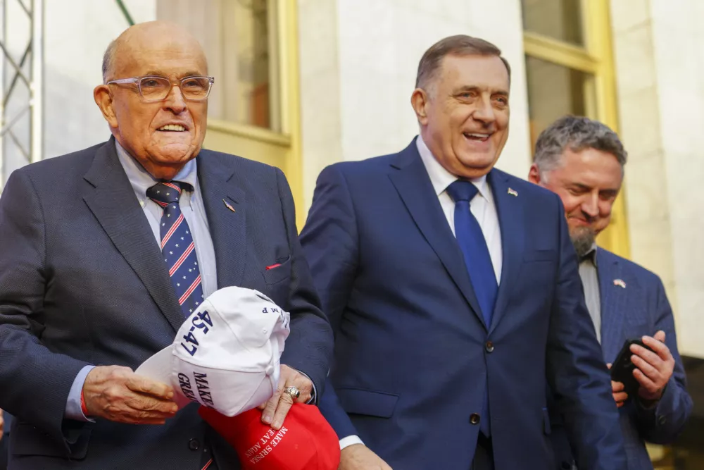 Bosnian Serb President Milorad Dodik, center, and former New York City mayor Rudy Giuliani, left, smile, during a rally on the eve of a scheduled court verdict that could order the pro-Russia Serb leader banned from politics or even sentenced to prison in the Bosnian town of Banja Luka, 240 kms northwest of Sarajevo, Tuesday, Feb. 25, 2025. (AP Photo/Radivoje Pavicic)