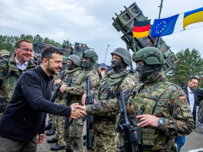 Ukrainian President Volodymyr Zelenskiy interacts with soldiers during his visit to a military training area to find out about the training of Ukrainian soldiers on the ?Patriot? anti-aircraft missile system, at an undisclosed location, in Germany, June 11, 2024.  Jens Buttner/Pool via REUTERS/File Photo