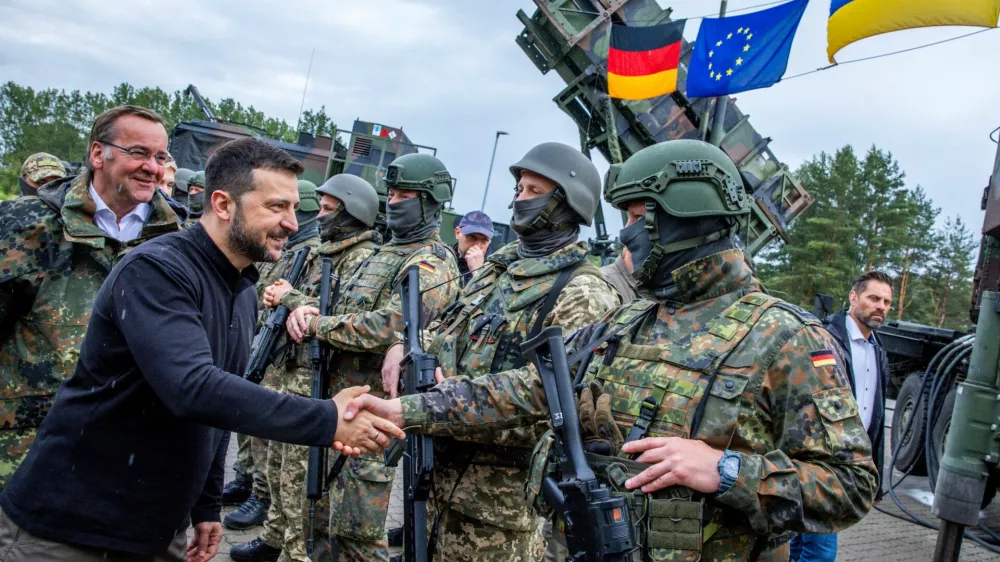 Ukrainian President Volodymyr Zelenskiy interacts with soldiers during his visit to a military training area to find out about the training of Ukrainian soldiers on the ?Patriot? anti-aircraft missile system, at an undisclosed location, in Germany, June 11, 2024.  Jens Buttner/Pool via REUTERS/File Photo