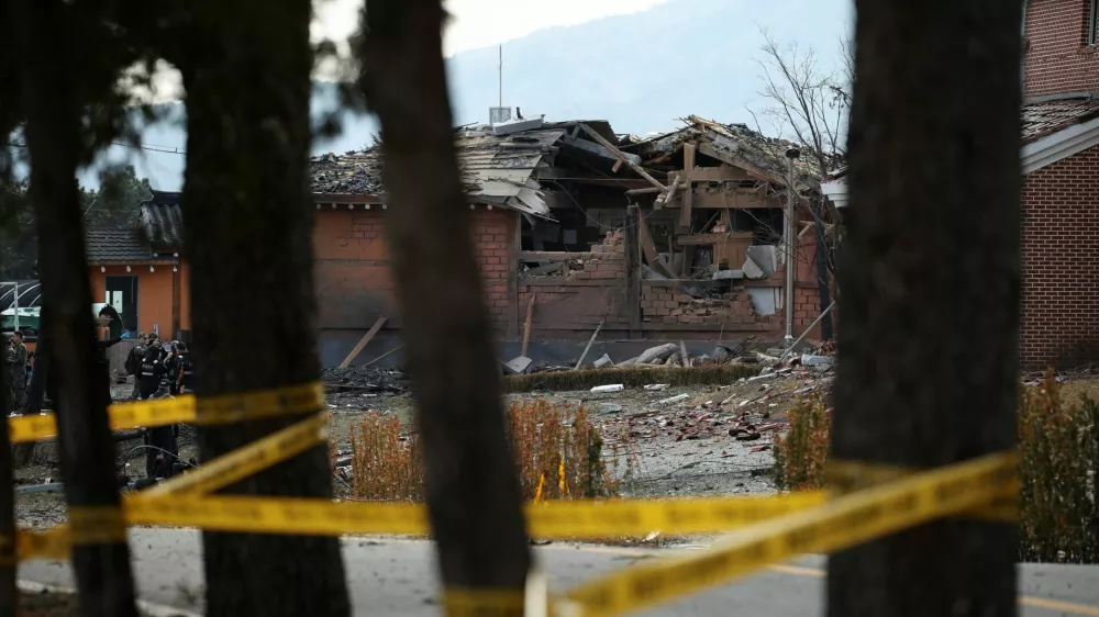 Officials stand near damaged buildings after South Korea's Air Force said that Mk82 bombs fell from a KF-16 jet outside the shooting range during joint live-fire exercises near the demilitarized zone separating two Koreas in Pocheon, South Korea, March 6, 2025. REUTERS/Kim Hong-Ji