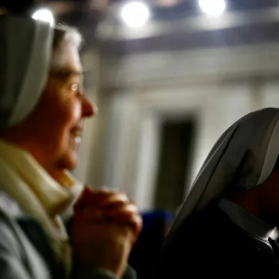FILE PHOTO: Faithful listen to an audio message by Pope Francis at the Vatican, March 6, 2025. REUTERS/Yara Nardi/File Photo