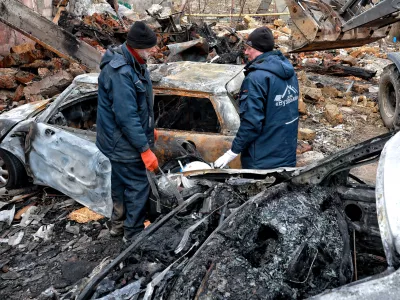 FILED - 04 March 2025, Ukraine, Odesa: Utility workers stand next to the cars burned down as a result of a Russian drone attack on Odesa. Photo: Nina Liashonok/Ukrinform/dpa