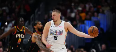Mar 7, 2025; Denver, Colorado, USA; Phoenix Suns center Nick Richards (2) defends on Denver Nuggets center Nikola Jokic (15) in the first quarter at Ball Arena. Mandatory Credit: Ron Chenoy-Imagn Images