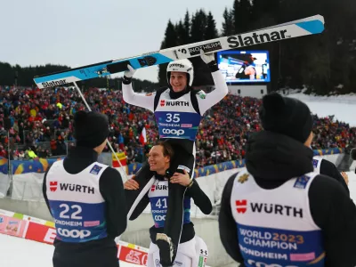 Nordic Skiing - FIS Nordic World Ski Championships - Trondheim, Norway - March 8, 2025 Slovenia's Domen Prevc celebrates winning the men's large hill alongside Slovenia's Anze Lanisek REUTERS/Kai Pfaffenbach