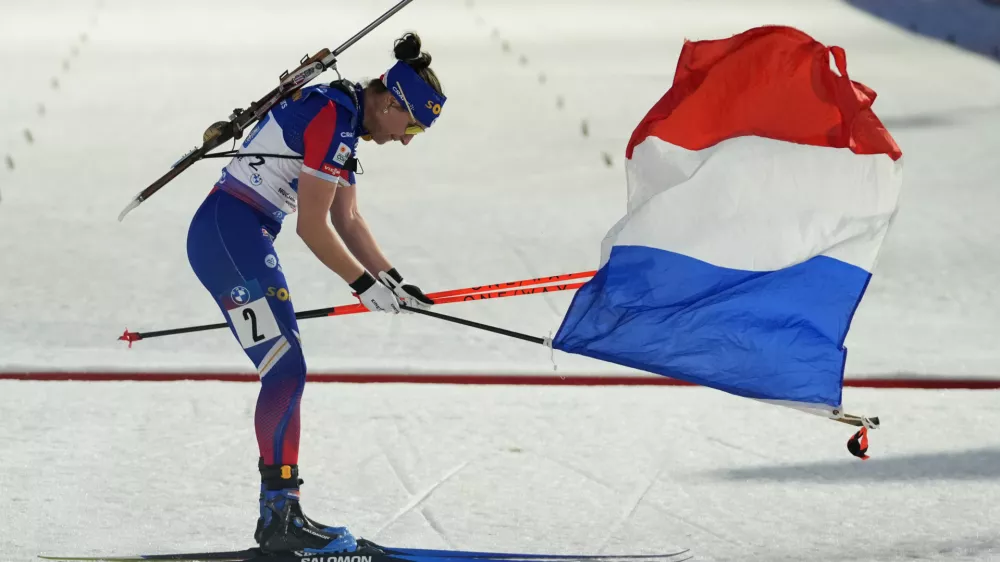 Julia Simon of France celebrates after winning the women's 4x6 km relay race at the Biathlon World World Cup in Nove Mesto na Morave, Czech Republic, Sunday, March 9, 2025. (AP Photo/Petr David Josek)