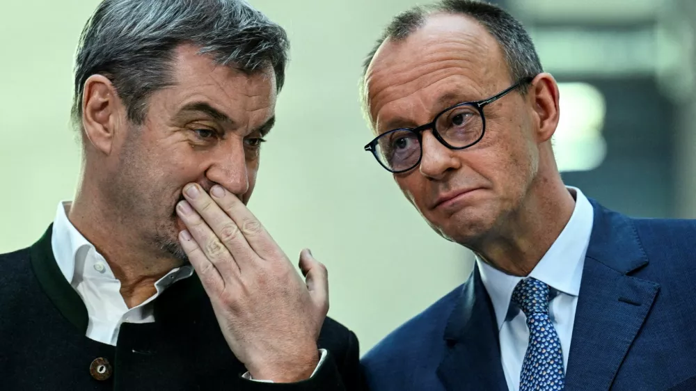 FILE PHOTO: Germany's chancellor-in-waiting and leader of the Christian Democratic Union party (CDU) Friedrich Merz speaks with Bavarian state premier and leader of the Christian Social Union (CSU) Markus Soeder as they give a statement with co-leaders of the Social Democratic party (SPD) Saskia Esken and Lars Klingbeil, after exploratory talks in Berlin, Germany March 8, 2025. REUTERS/Annegret Hilse/File Photo