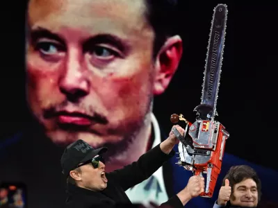 21 February 2025, US, Oxen Hill: Elon Musk is given a chainsaw as a gift by Argentine President Javier Millei during his appearance at CPAC, the annual Conservative Political Action Conference at the Gaylord Convention Center in Oxen Hill MD. Photo: Carol Guzy/ZUMA Press Wire/dpa