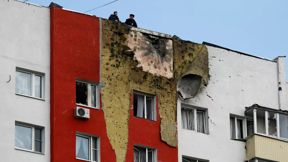 Police officers stand on the roof of a multi-storey residential building damaged in a recent Ukrainian drone attack, according to local authorities, in the course of Russia-Ukraine conflict, in Moscow, Russia March 11, 2025. REUTERS/Stringer   TPX IMAGES OF THE DAY