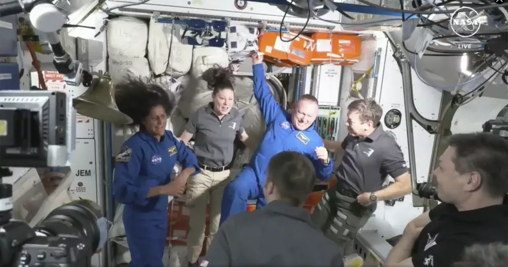 NASA astronauts Butch Wilmore and Suni Williams are greeted by the crew of the International Space Station on Thursday, June 6, 2024. (NASA via AP)