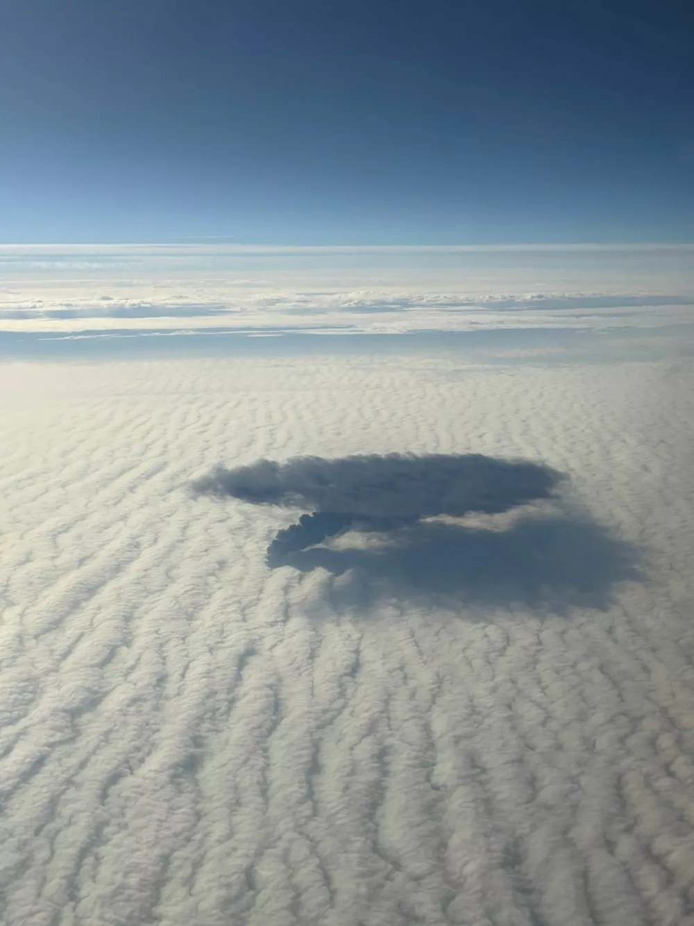 Plumes of smoke rise above clouds after Portuguese-flagged container ship, Solong, crashed into anchored Stena Immaculate, a tanker carrying U.S. military jet fuel, off Britain's east coast, as seen from mid-air, in this handout image obtained by Reuters on March 11, 2025. Paige Langley/Handout via REUTERS  THIS IMAGE HAS BEEN SUPPLIED BY A THIRD PARTY. NO RESALES. NO ARCHIVES.