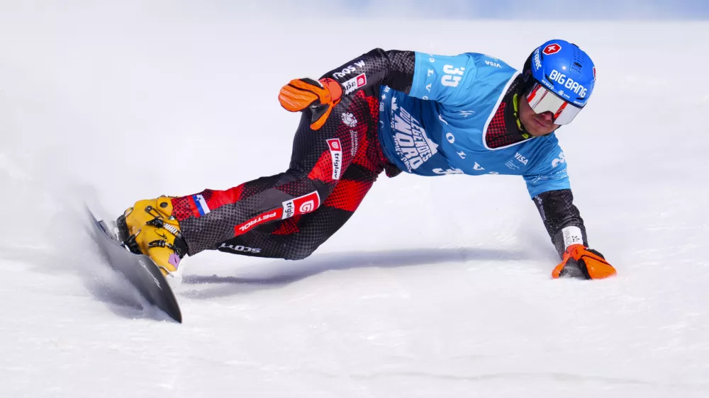 Slovakian Zan Kosir races in qualification round of the men's parallel slalom FIS Snowboard Alpine World Cup at Val Saint-Come in Saint-Come, Quebec, Canada, on Saturday, Feb. 15, 2025. (Sean Kilpatrick/The Canadian Press via AP)