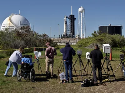 Photographers set up remote cameras for a SpaceX Falcon 9 rocket launch outside Launch Complex 39A where it is scheduled to carry a crew of four to the International Space Station from the Kennedy Space Center in Cape Canaveral, Florida, U.S. March 12, 2025. REUTERS/Steve Nesius