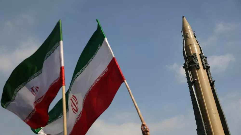 FILE PHOTO: People wave flags next to an Iranian missile on display during the 46th anniversary of the Islamic Revolution in Tehran, Iran, February 10, 2025. Majid Asgaripour/WANA (West Asia News Agency) via REUTERS ATTENTION EDITORS - THIS PICTURE WAS PROVIDED BY A THIRD PARTY/File Photo