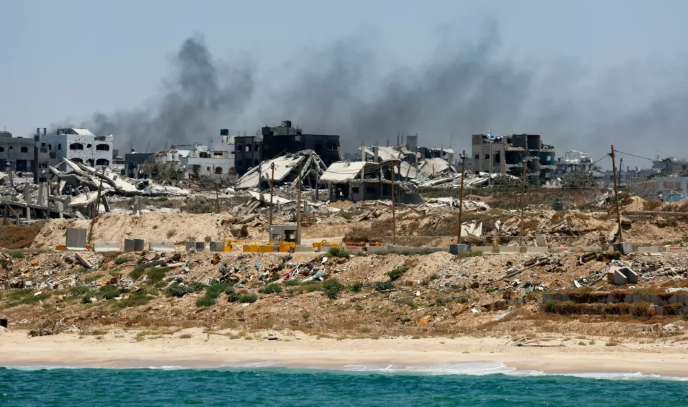 FILE PHOTO: Destroyed buildings are pictured in Gaza, amid the ongoing conflict between Israel and Hamas, as seen near the Gaza coast, June 25, 2024. REUTERS/Amir Cohen/File Photo