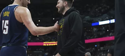 Denver Nuggets center Nikola Jokic, left, greets Los Angeles Lakers guard Luka Doncic, right, in the first half of an NBA basketball game Friday, March 14, 2025, in Denver. (AP Photo/David Zalubowski)