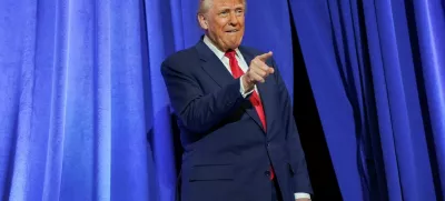 U.S. President Donald Trump gestures during his visit to the Department of Justice to address its workers, in Washington, D.C., U.S., March 14, 2025. REUTERS/Nathan Howard