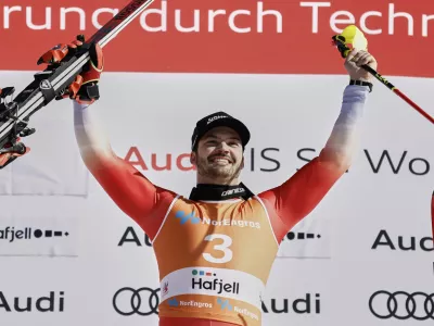 Switzerland's Loic Meillard celebrates on the podium after winning an alpine ski, men's World Cup slalom, in Hafjell, Norway, Sunday, March 16, 2025. (AP Photo/Gabriele Facciotti)