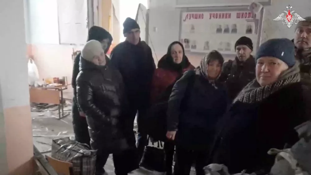 People gather inside a school building as Russian service members evacuate civilians from the settlements of Kazachya Loknya and Sudzha, which were recently retaken by Russia's armed forces in the course of Russia-Ukraine conflict in the Kursk region, Russia, in this still image from video released March 16, 2025. Russian Defence Ministry/Handout via REUTERS ATTENTION EDITORS - THIS IMAGE HAS BEEN SUPPLIED BY A THIRD PARTY. NO RESALES. NO ARCHIVES. MANDATORY CREDIT. WATERMARK FROM SOURCE.