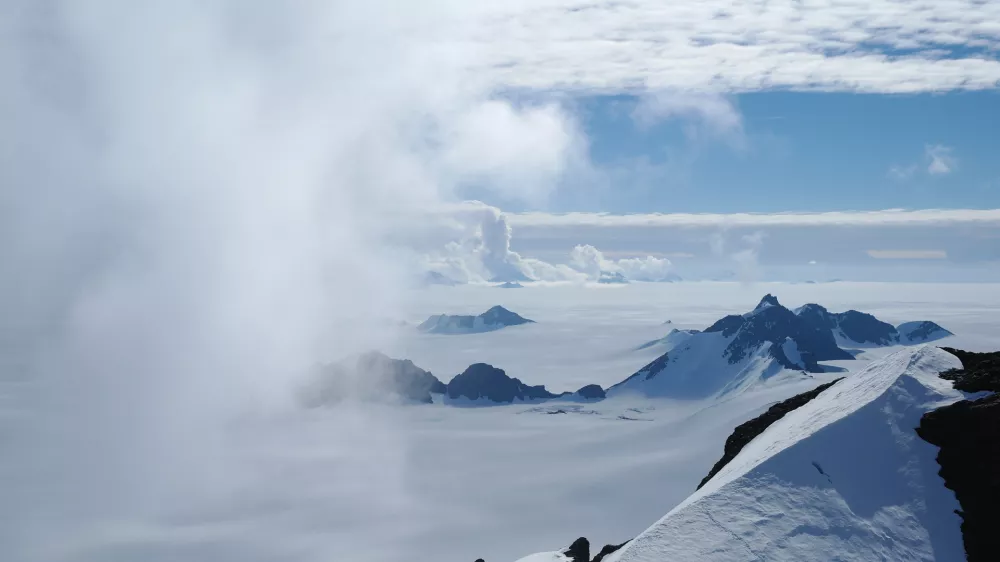 In this 2011 photo provided by researcher Hamish Pritchard, summer clouds swirl around the Staccato Peaks of Alexander Island off the Antarctic Peninsula. In a study released Wednesday, June 13, 2018, an international team of ice experts said the melting of Antarctica is accelerating at an alarming rate, with about 3 trillion tons of ice disappearing since 1992.&Acirc;&nbsp;&acirc;&euro;&uml;(Hamish Pritchard/British Antarctic Survey via AP)