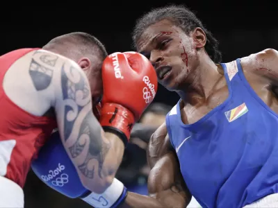 Seychelles' Andrique Allisop, right, fights Ireland's David Joyce during a men's lightweight 60-kg preliminary boxing match at the 2016 Summer Olympics in Rio de Janeiro, Brazil, Sunday, Aug. 7, 2016. (AP Photo/Frank Franklin II)