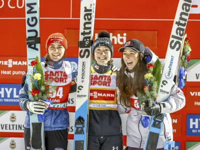 Winner Nika Prevc of Slovenia, centre, second-placed Selina Freitag of Germany, left, and third-placed Alexandria Loutitt of Canada celebrate in the podium of the women's HS130 ski jumping competition at the FIS Nordic World Cup Lahti Ski Games in Lahti, Finland, Thursday March 20, 2025. (Pepe Korteniemi/Lehtikuva via AP)