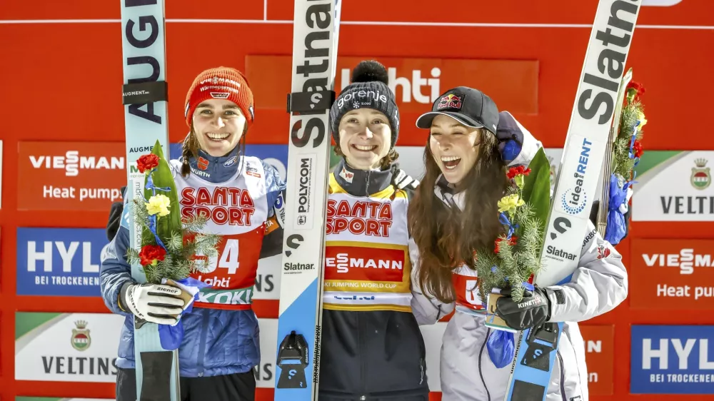 Winner Nika Prevc of Slovenia, centre, second-placed Selina Freitag of Germany, left, and third-placed Alexandria Loutitt of Canada celebrate in the podium of the women's HS130 ski jumping competition at the FIS Nordic World Cup Lahti Ski Games in Lahti, Finland, Thursday March 20, 2025. (Pepe Korteniemi/Lehtikuva via AP)