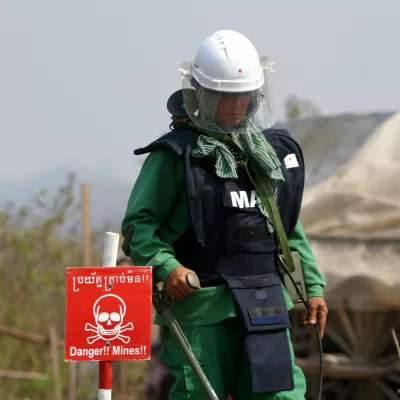 Cambodian woman On Sovannareth, 30, searches for mines in a minefield near the village of Ta Krouk, some 350km northwest of the capital Phnom Penh. As a member of what is one of the world's first all-women demining teams, she is working to clear mines and unexploded bombs left from decades of conflict in the impoverished southeast Asian nation. Picture taken February 11, 2004. TO MATCH FEATURE CAMBODIA-MINES REUTERS/Chor Sokunthea