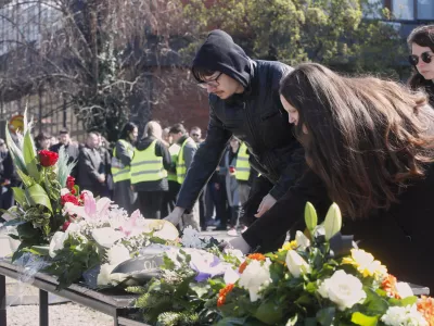 People lay flowers for the victims of a massive nightclub fire in the town of Kocani, in Skopje, North Macedonia, Tuesday, March 18, 2025. (AP Photo/Boris Grdanoski)